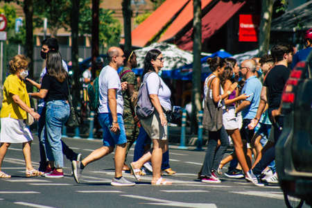 Seville Spain September 18, 2021 Pedestrians walking in the street during the coronavirus outbreak hitting Spain, wearing a mask is not mandatory but most of people wear itのeditorial素材