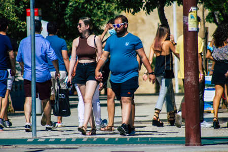 Seville Spain September 18, 2021 Pedestrians walking in the street during the coronavirus outbreak hitting Spain, wearing a mask is not mandatory but most of people wear itのeditorial素材