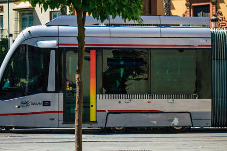 Seville Spain September 04, 2021 Modern electric tram for passengers rolling through the streets of Seville during the coronavirus outbreak hitting Spain, wearing a mask is mandatoryのeditorial素材