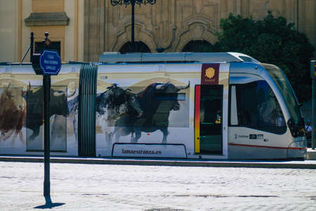 Seville Spain September 04, 2021 Modern electric tram for passengers rolling through the streets of Seville during the coronavirus outbreak hitting Spain, wearing a mask is mandatoryのeditorial素材