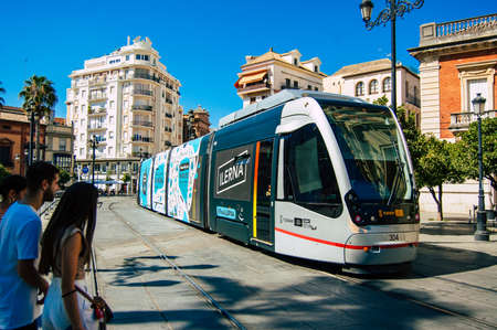 Seville Spain September 04, 2021 Modern electric tram for passengers rolling through the streets of Seville during the coronavirus outbreak hitting Spain, wearing a mask is mandatoryのeditorial素材