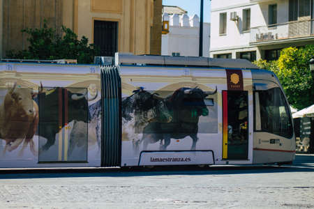 Seville Spain September 04, 2021 Modern electric tram for passengers rolling through the streets of Seville during the coronavirus outbreak hitting Spain, wearing a mask is mandatoryのeditorial素材