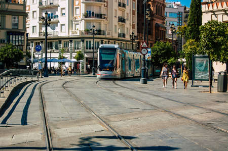 Seville Spain September 04, 2021 Modern electric tram for passengers rolling through the streets of Seville during the coronavirus outbreak hitting Spain, wearing a mask is mandatoryのeditorial素材