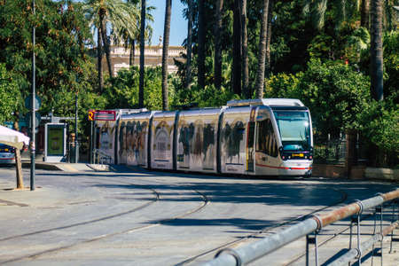 Seville Spain September 04, 2021 Modern electric tram for passengers rolling through the streets of Seville during the coronavirus outbreak hitting Spain, wearing a mask is mandatoryのeditorial素材