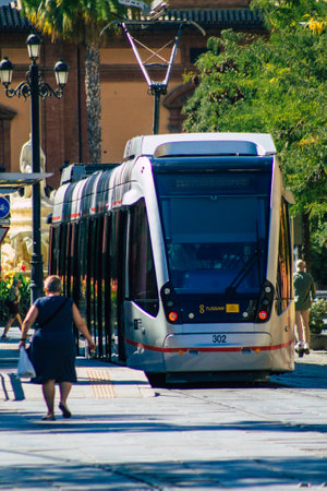Seville Spain September 04, 2021 Modern electric tram for passengers rolling through the streets of Seville during the coronavirus outbreak hitting Spain, wearing a mask is mandatoryのeditorial素材