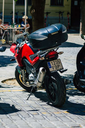 Seville Spain September 04, 2021 Motorcycles parked in the streets of Seville, an emblematic city and the capital of the region of Andalusia, in the south of Spainのeditorial素材