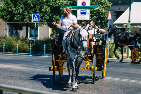 Seville Spain September 04, 2021 Horse drawn carriage ride through the streets of Seville during the coronavirus outbreak hitting Spain, wearing a mask is mandatoryのeditorial素材