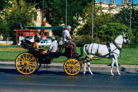 Seville Spain September 04, 2021 Horse drawn carriage ride through the streets of Seville during the coronavirus outbreak hitting Spain, wearing a mask is mandatoryのeditorial素材