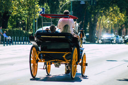 Seville Spain September 04, 2021 Horse drawn carriage ride through the streets of Seville during the coronavirus outbreak hitting Spain, wearing a mask is mandatoryのeditorial素材