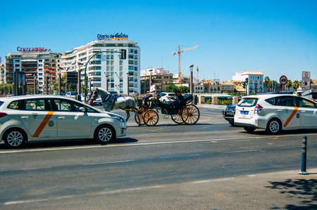 Seville Spain September 04, 2021 Horse drawn carriage ride through the streets of Seville during the coronavirus outbreak hitting Spain, wearing a mask is mandatoryのeditorial素材
