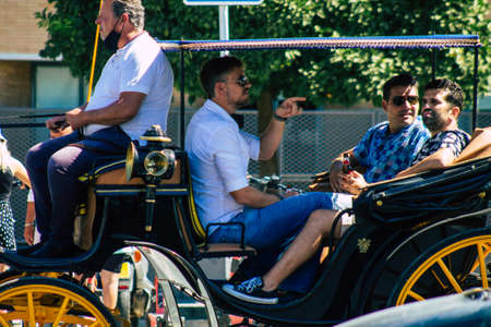 Seville Spain September 04, 2021 Horse drawn carriage ride through the streets of Seville during the coronavirus outbreak hitting Spain, wearing a mask is mandatoryのeditorial素材