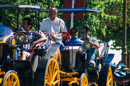 Seville Spain September 04, 2021 Horse drawn carriage ride through the streets of Seville during the coronavirus outbreak hitting Spain, wearing a mask is mandatoryのeditorial素材