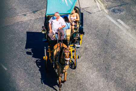 Seville Spain September 04, 2021 Horse drawn carriage ride through the streets of Seville during the coronavirus outbreak hitting Spain, wearing a mask is mandatoryのeditorial素材