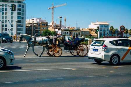 Seville Spain September 04, 2021 Horse drawn carriage ride through the streets of Seville during the coronavirus outbreak hitting Spain, wearing a mask is mandatoryのeditorial素材
