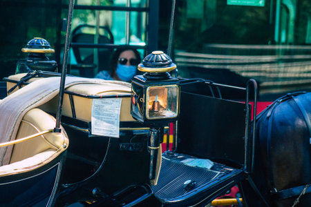 Seville Spain September 04, 2021 Horse drawn carriage ride through the streets of Seville during the coronavirus outbreak hitting Spain, wearing a mask is mandatoryのeditorial素材