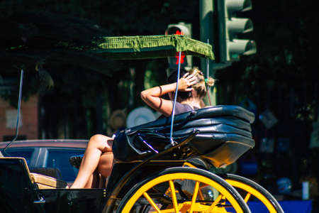 Seville Spain September 04, 2021 Horse drawn carriage ride through the streets of Seville during the coronavirus outbreak hitting Spain, wearing a mask is mandatoryのeditorial素材