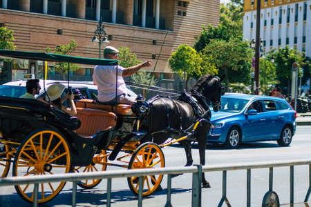 Seville Spain September 04, 2021 Horse drawn carriage ride through the streets of Seville during the coronavirus outbreak hitting Spain, wearing a mask is mandatoryのeditorial素材