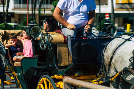 Seville Spain September 04, 2021 Horse drawn carriage ride through the streets of Seville during the coronavirus outbreak hitting Spain, wearing a mask is mandatoryのeditorial素材