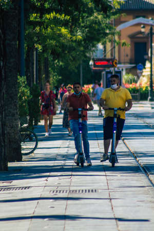 Seville Spain September 04, 2021 People rolling with an electric scooter in the streets of Seville, operating with a small utility internal combustion engines and a deck in the centerのeditorial素材