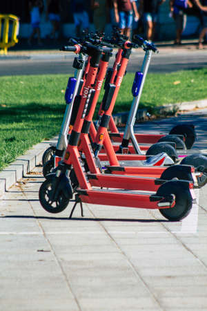 Seville Spain September 04, 2021 Electric scooter to rent parked in the streets of Seville, operating with a small utility internal combustion engines and a deck in the centerのeditorial素材