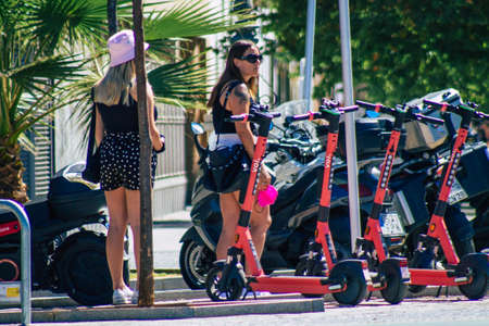 Seville Spain September 04, 2021 Electric scooter to rent parked in the streets of Seville, operating with a small utility internal combustion engines and a deck in the centerのeditorial素材