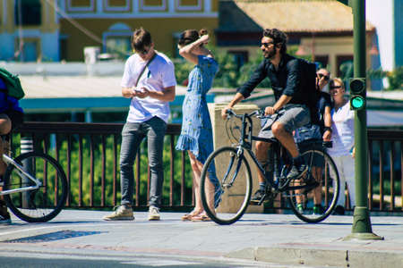 Seville Spain September 04, 2021 People rolling with a bicycle in the streets of Seville, an emblematic city and the capital of the region of Andalusia, in the south of Spainのeditorial素材