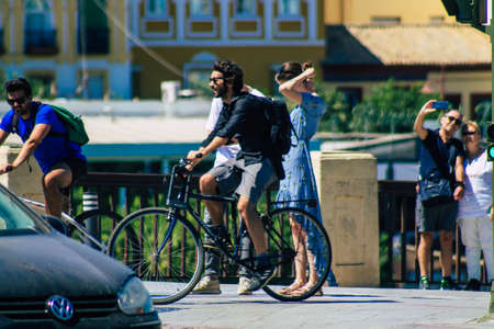 Seville Spain September 04, 2021 People rolling with a bicycle in the streets of Seville, an emblematic city and the capital of the region of Andalusia, in the south of Spainのeditorial素材