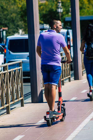 Seville Spain September 18, 2021 People rolling with an electric scooter in the streets of Seville,...