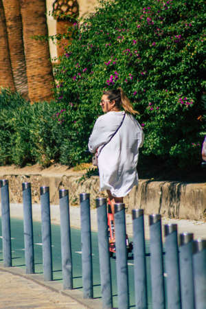 Seville Spain September 18, 2021 People rolling with an electric scooter in the streets of Seville, operating with a small utility internal combustion engines and a deck in the centerのeditorial素材