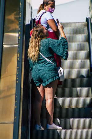 Seville Spain September 18, 2021 Pedestrians using an escalator during the coronavirus outbreak hitting Spain, wearing a mask is not mandatory but most of people wear itのeditorial素材