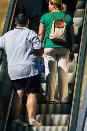 Seville Spain September 18, 2021 Pedestrians using an escalator during the coronavirus outbreak hitting Spain, wearing a mask is not mandatory but most of people wear itのeditorial素材
