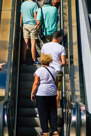 Seville Spain September 18, 2021 Pedestrians using an escalator during the coronavirus outbreak hitting Spain, wearing a mask is not mandatory but most of people wear itのeditorial素材