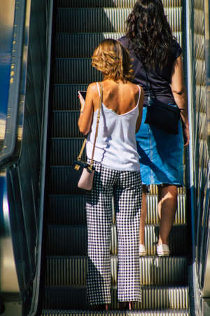 Seville Spain September 18, 2021 Pedestrians using an escalator during the coronavirus outbreak hitting Spain, wearing a mask is not mandatory but most of people wear itのeditorial素材