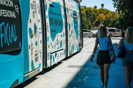 Seville Spain September 18, 2021 Modern electric tram for passengers rolling through the streets of Seville during the coronavirus outbreak hitting Spain, wearing a mask is mandatoryのeditorial素材
