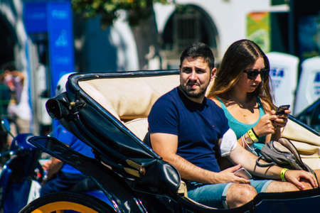 Seville Spain September 18, 2021 Horse drawn carriage ride through the streets of Seville during the coronavirus outbreak hitting Spain, wearing a mask is mandatoryのeditorial素材