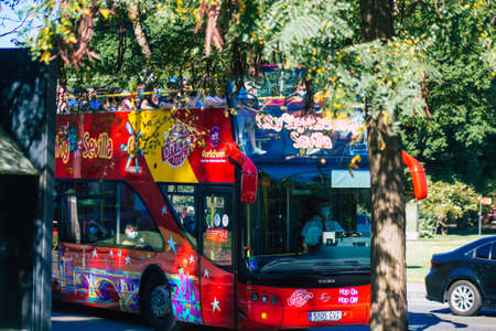 Seville Spain September 18, 2021 Tourist bus driving through the streets of Seville during the coronavirus outbreak hitting Spain, wearing a mask is mandatoryのeditorial素材