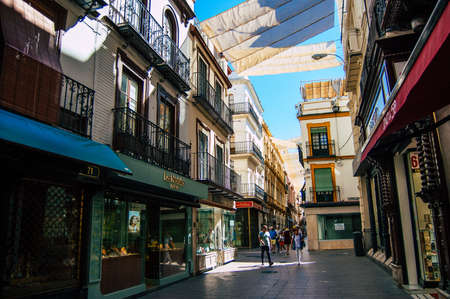 Seville Spain September 18, 2021 Pedestrians walking in the street during the coronavirus outbreak hitting Spain, wearing a mask is not mandatory but most of people wear itのeditorial素材