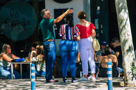 Seville Spain September 18, 2021 Pedestrians walking in the street during the coronavirus outbreak hitting Spain, wearing a mask is not mandatory but most of people wear itのeditorial素材