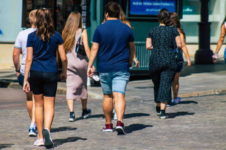 Seville Spain September 18, 2021 Pedestrians walking in the street during the coronavirus outbreak hitting Spain, wearing a mask is not mandatory but most of people wear itのeditorial素材