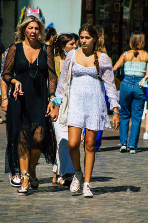 Seville Spain September 18, 2021 Pedestrians walking in the street during the coronavirus outbreak hitting Spain, wearing a mask is not mandatory but most of people wear itのeditorial素材