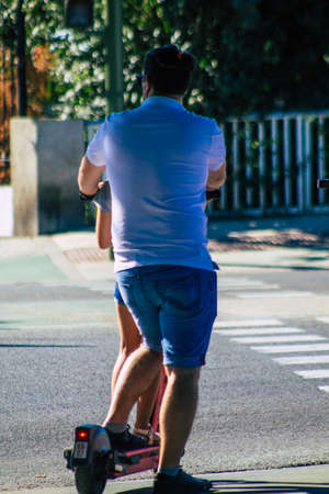 Seville Spain September 18, 2021 People rolling with an electric scooter in the streets of Seville,...