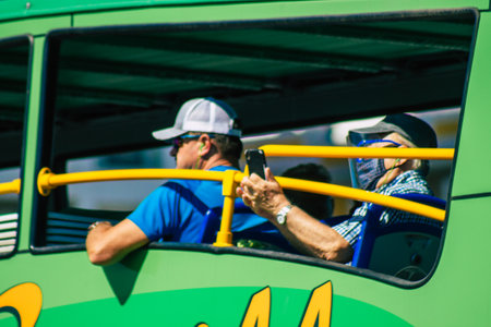 Seville Spain September 18, 2021 Tourist bus driving through the streets of Seville during the coronavirus outbreak hitting Spain, wearing a mask is mandatoryのeditorial素材