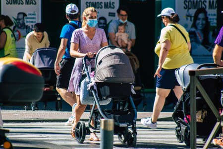 Seville Spain September 18, 2021 Pedestrians walking in the street during the coronavirus outbreak hitting Spain, wearing a mask is not mandatory but most of people wear itのeditorial素材