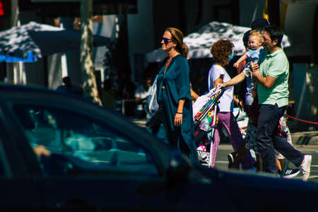 Seville Spain September 18, 2021 Pedestrians walking in the street during the coronavirus outbreak hitting Spain, wearing a mask is not mandatory but most of people wear itのeditorial素材