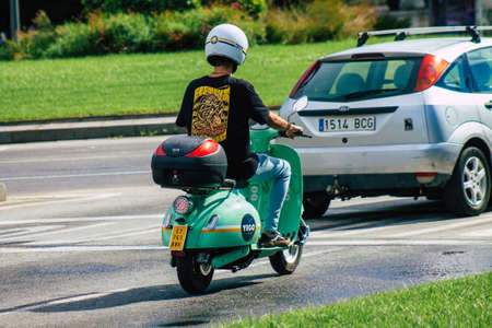 Seville Spain September 15, 2021 People rolling with a scooter in the streets of Seville, an emblematic city and the capital of the region of Andalusia, in the south of Spainのeditorial素材