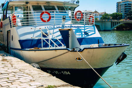 Seville Spain September 18, 2021 Tourist boats on the Guadalquivir River that crosses Seville, an emblematic city and the capital of the region of Andalusia, in the south of Spainのeditorial素材