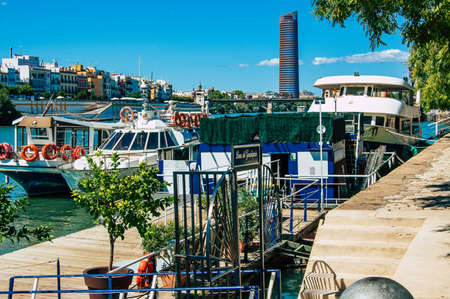 Seville Spain September 18, 2021 Tourist boats on the Guadalquivir River that crosses Seville, an emblematic city and the capital of the region of Andalusia, in the south of Spainのeditorial素材