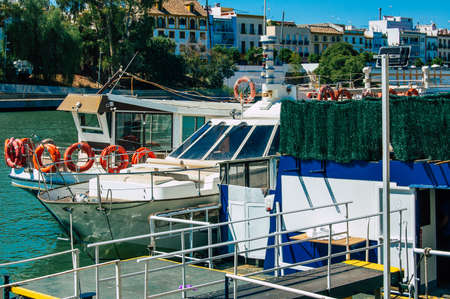 Seville Spain September 18, 2021 Tourist boats on the Guadalquivir River that crosses Seville, an emblematic city and the capital of the region of Andalusia, in the south of Spainのeditorial素材