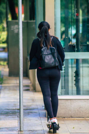 Seville Spain September 15, 2021 People rolling with an electric scooter in the streets of Seville, operating with a small utility internal combustion engines and a deck in the centerのeditorial素材