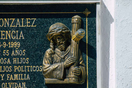 Seville Spain September 21, 2021 Typical graves in a Christian cemetery of the municipality of Carmona in Andalusia in southern Spain, the graves are made in the depth of a wall and richly decoratedのeditorial素材